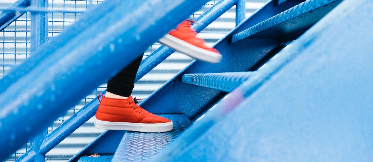 orange shoes on a blue staircase