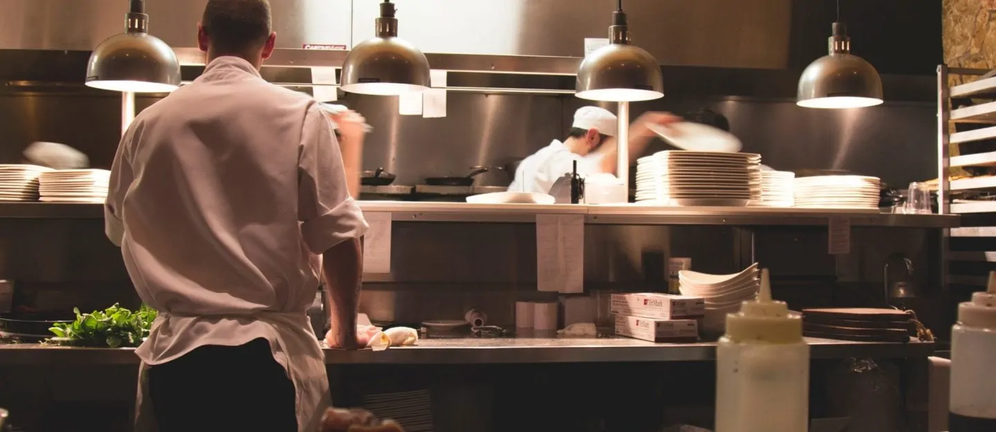 men cooking in a kitchen of a restaurant