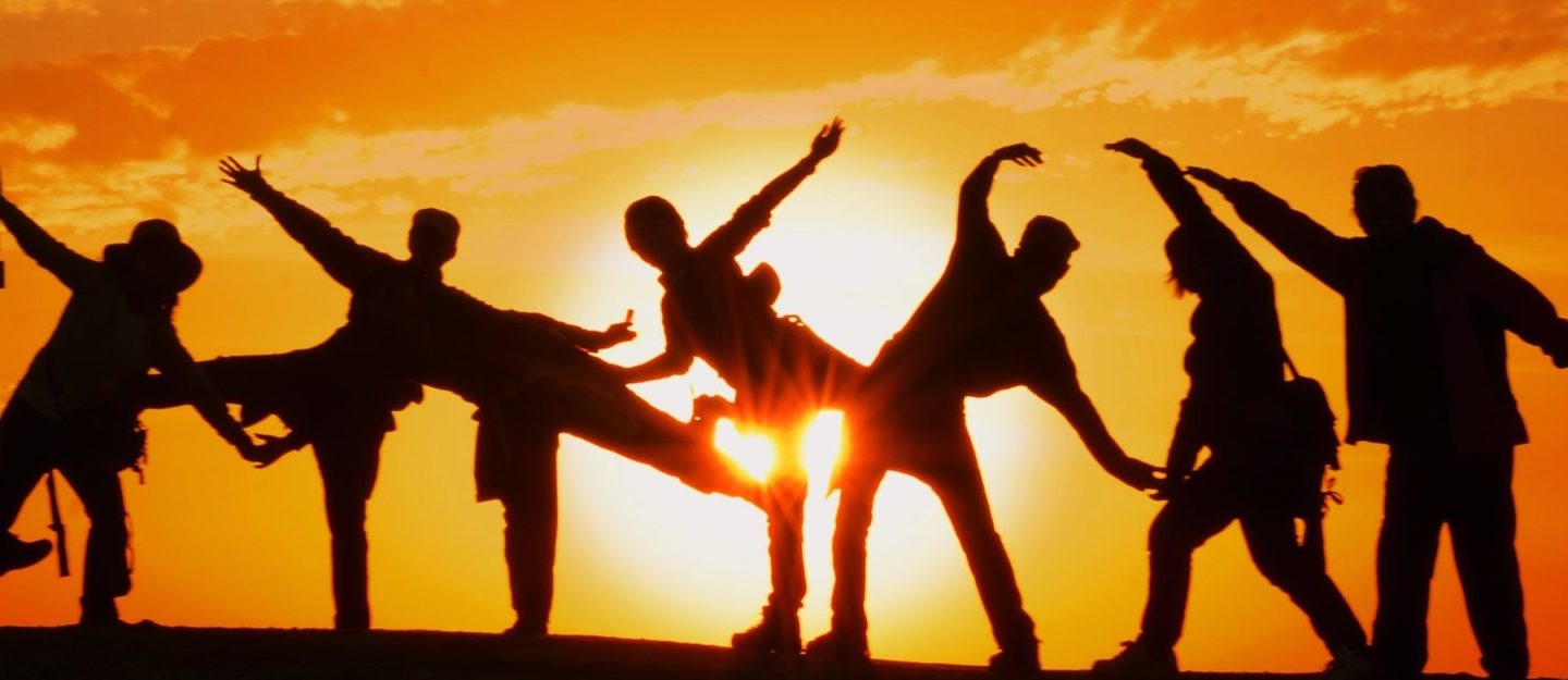 people dancing in sunset
