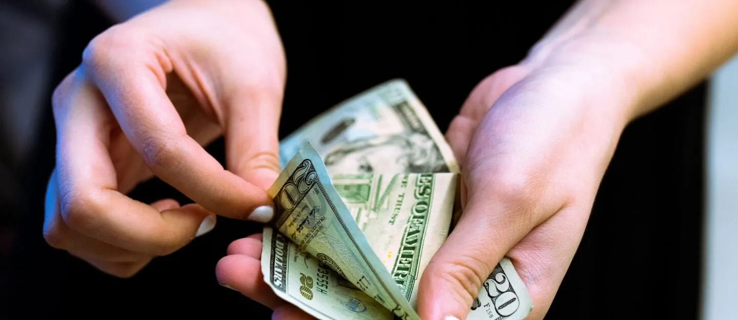person holds money in hands