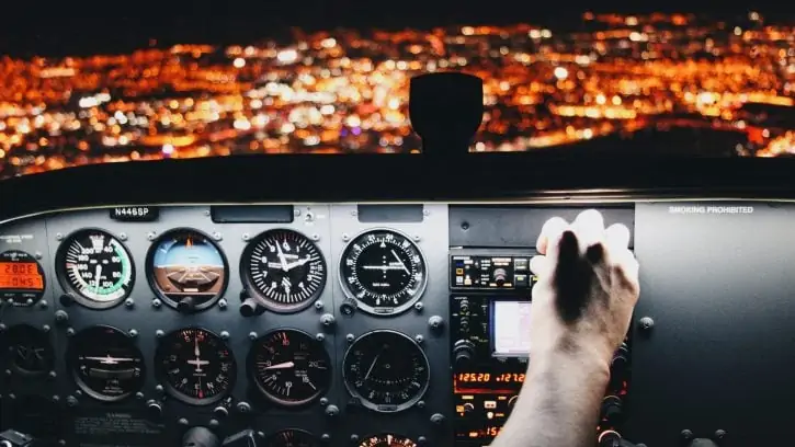 person holding airplane control panel